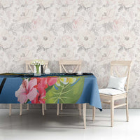 Blue hibiscus and palm leaf tablecloth laid on dining table