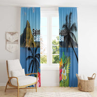 Blue window curtains featuring palm leaves and colorful hibiscus flower print