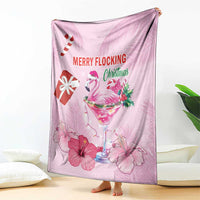 Pink Christmas blanket with flamingo, candy cane, martini glass, and hibiscus flowers