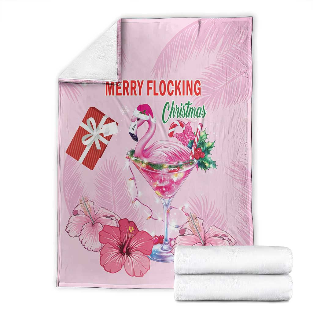 Pink Christmas blanket, flamingo and “MERRY FLOCKING Christmas” over hibiscus flowers