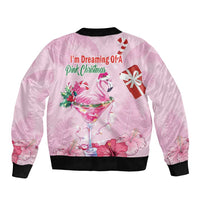 Pink unisex bomber jacket with black ribbed trim and flamingo holiday print