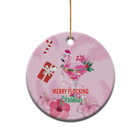 Pink round flamingo Christmas ceramic ornament with gold hanging loop; “MERRY FLOCKING” text.