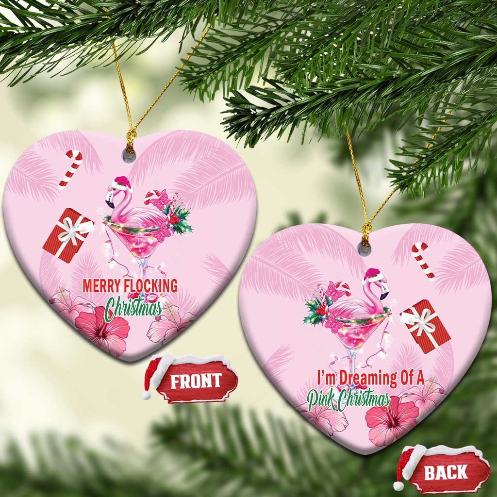 Pink flamingo Christmas ceramic heart ornament with gold loop; “MERRY FLOCKING Christmas”.