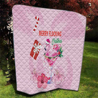 Pink quilt laid flat on grass, diamond quilting with flamingo and Merry Flocking