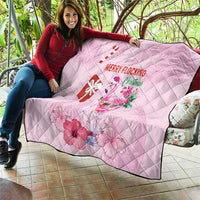 Pink Christmas quilt draped over seating, diamond quilting with flamingo and Merry Flocking
