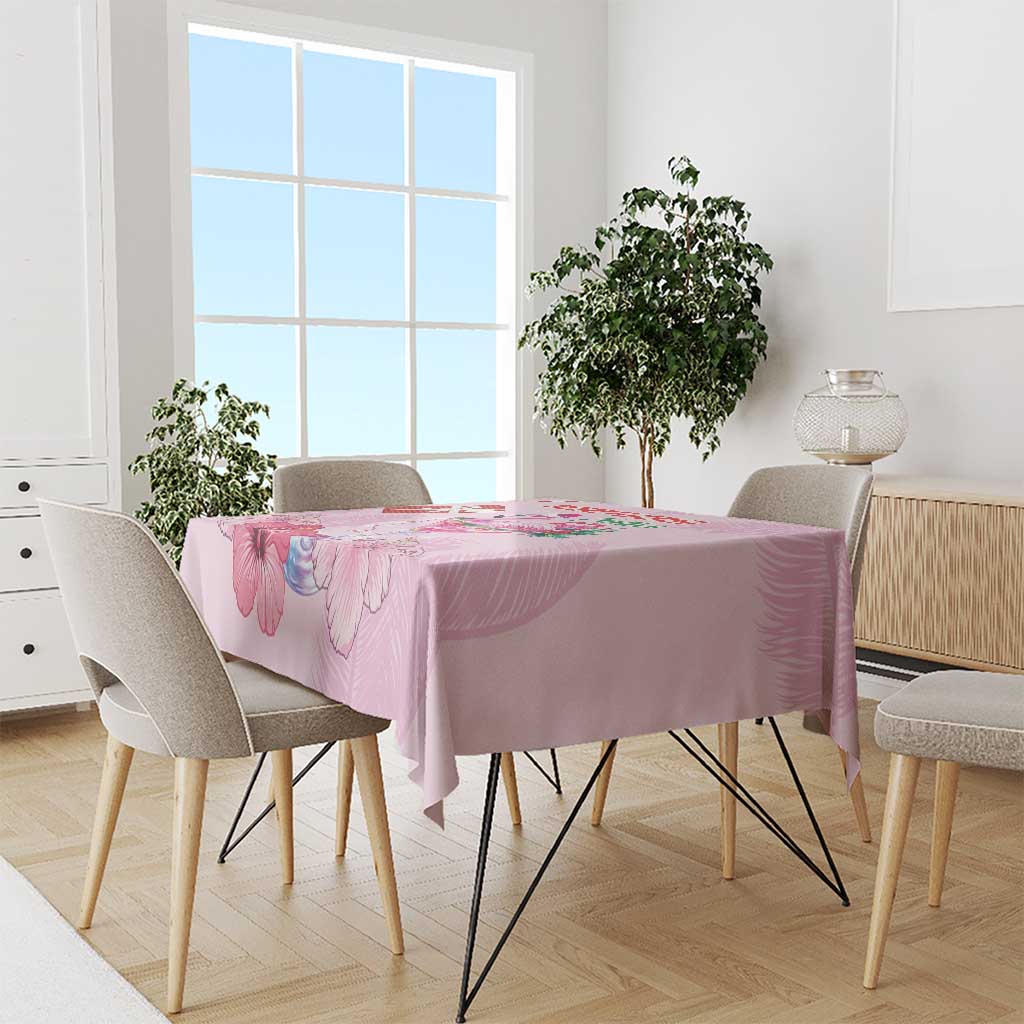 Pink Christmas tablecloth with floral print on dining table with four chairs