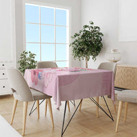 Pink Christmas tablecloth with floral print on dining table with four chairs