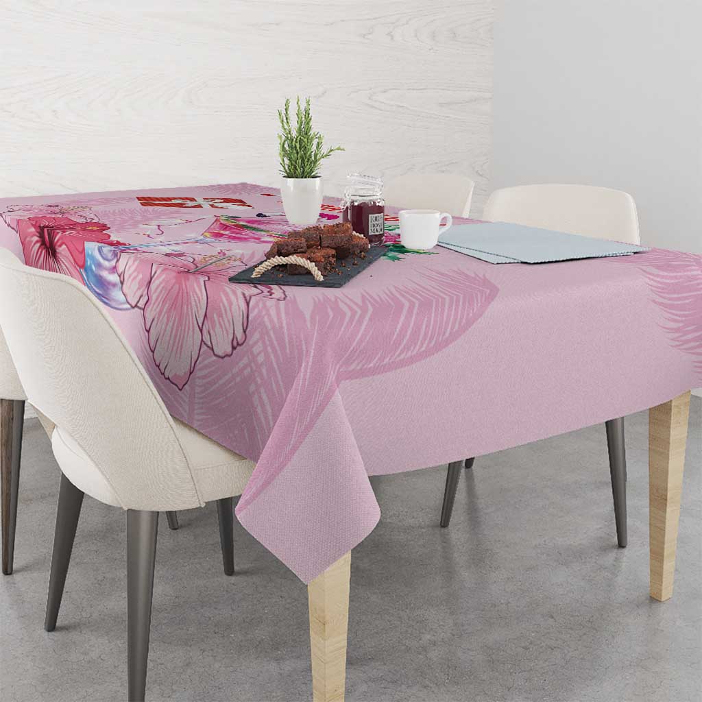 Pink Christmas tablecloth with floral and flamingo print on dining table, corner view