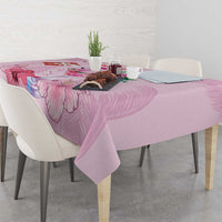Pink Christmas tablecloth with floral and flamingo print on dining table, corner view