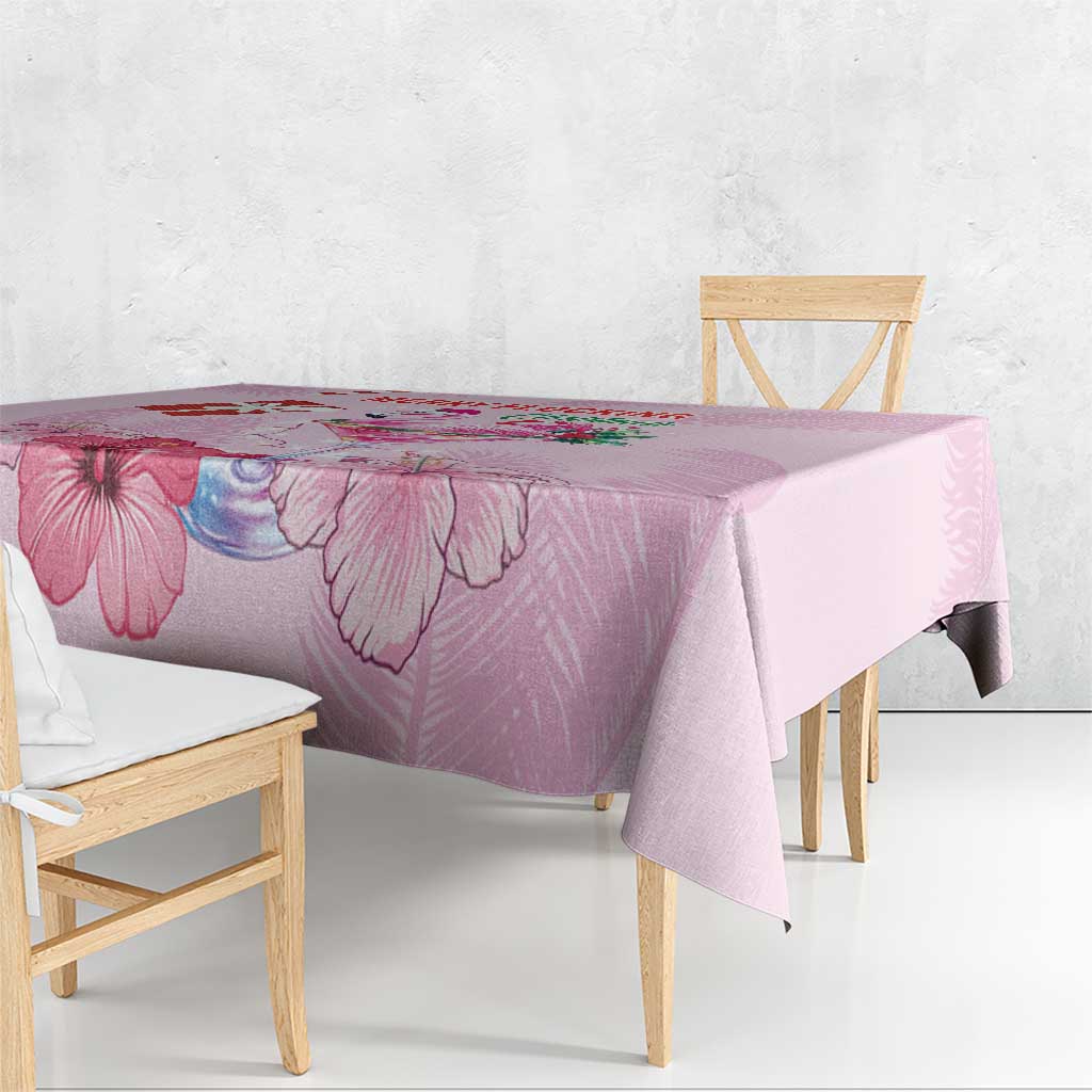 Pink Christmas tablecloth with large floral print, draped over dining table edge
