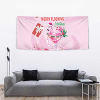 Pink Christmas wall tapestry with flamingo martini, gift icon, candy cane, and 'Merry Flocking'