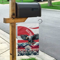 Austria garden flag hanging from a wooden post with black eagle and edelweiss bloom