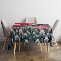 Blue-black floral tablecloth with red border stripe over a square dining table