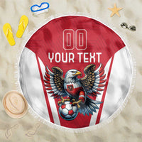 Red and white round beach blanket with eagle mascot graphic and white fringe edge