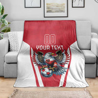 Red and white football blanket on grey sofa, eagle mascot, 'YOUR TEXT', and '00' center design.