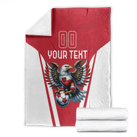 Red and white football blanket with eagle graphic, 'YOUR TEXT' and '00' on folded stack.
