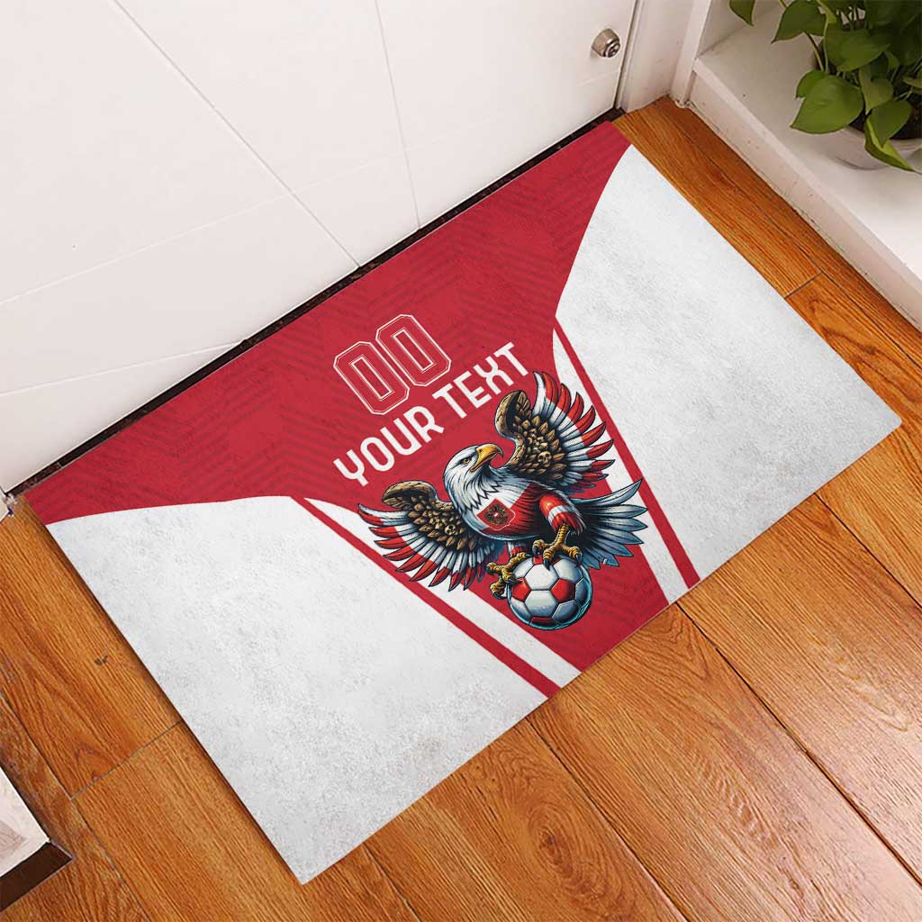 Red rubber doormat with eagle and soccer ball center graphic and white border.