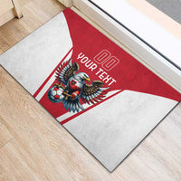 Red rubber doormat with '00' and 'YOUR TEXT' over eagle-and-soccer graphic.