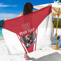 Red and white football team sarong with eagle mascot graphic, close drape view