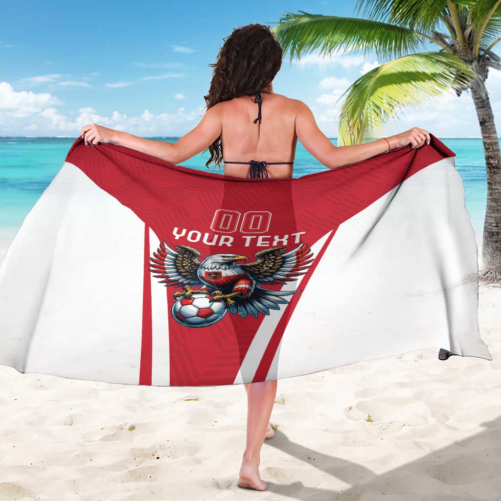 Red and white football team sarong with eagle mascot graphic, held wide