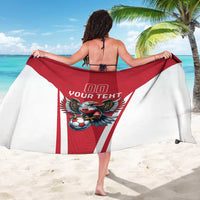 Red and white football team sarong with eagle mascot graphic, held wide