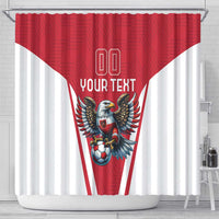 Red shower curtain with eagle soccer mascot and customizable text, hanging with top rings