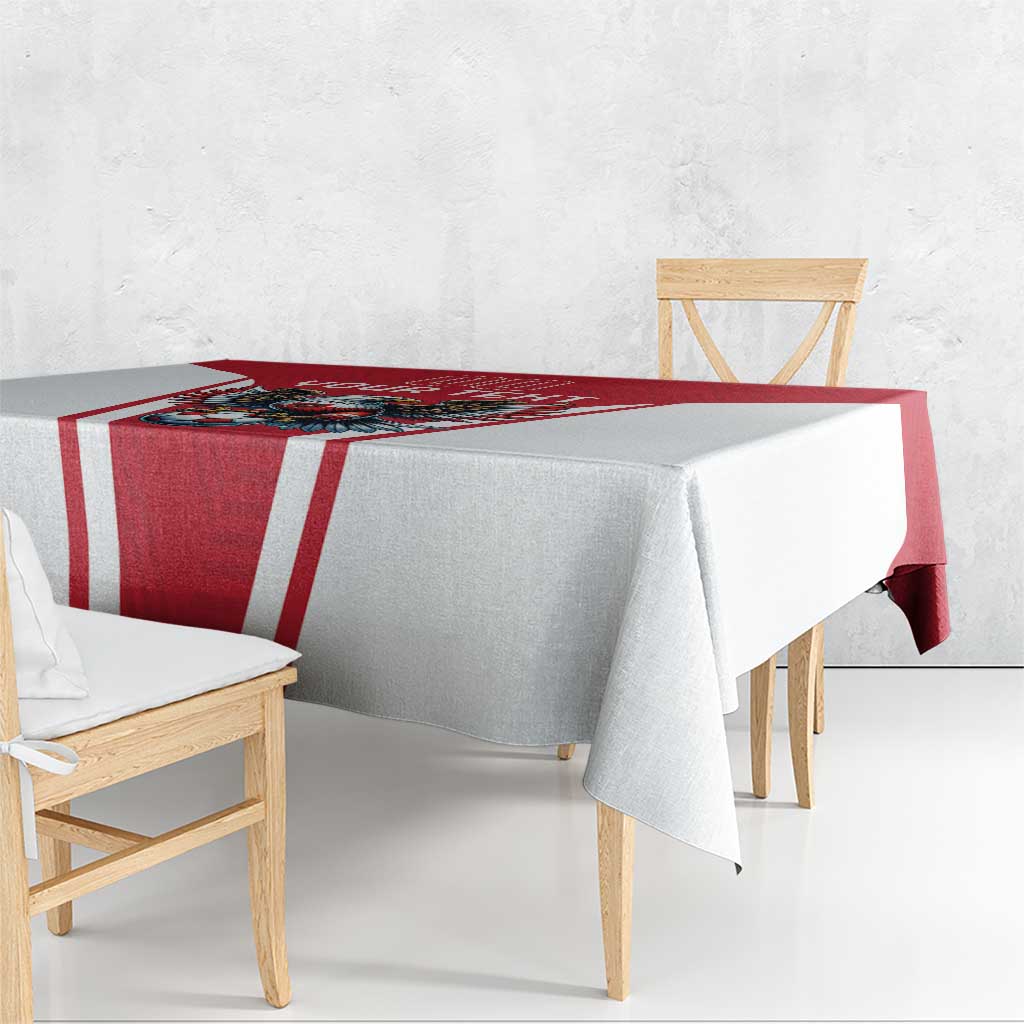 Red and white football tablecloth draped over table edge, eagle and soccer graphic