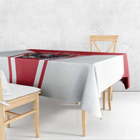 Red and white football tablecloth draped over table edge, eagle and soccer graphic