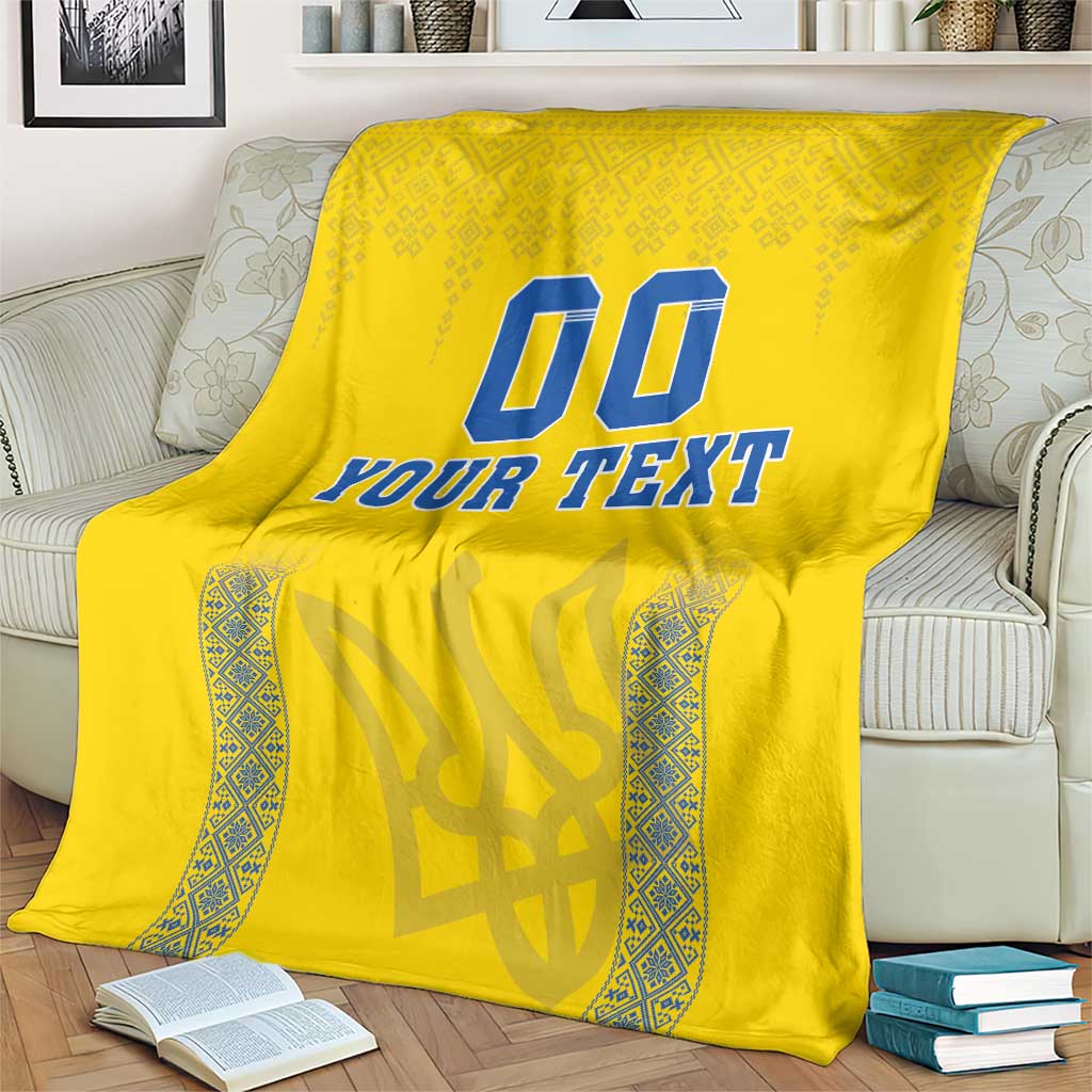 Yellow football blanket with blue “00” and “YOUR TEXT” text, patterned side accents
