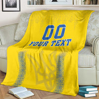 Yellow football blanket with blue “00” and “YOUR TEXT” text, patterned side accents