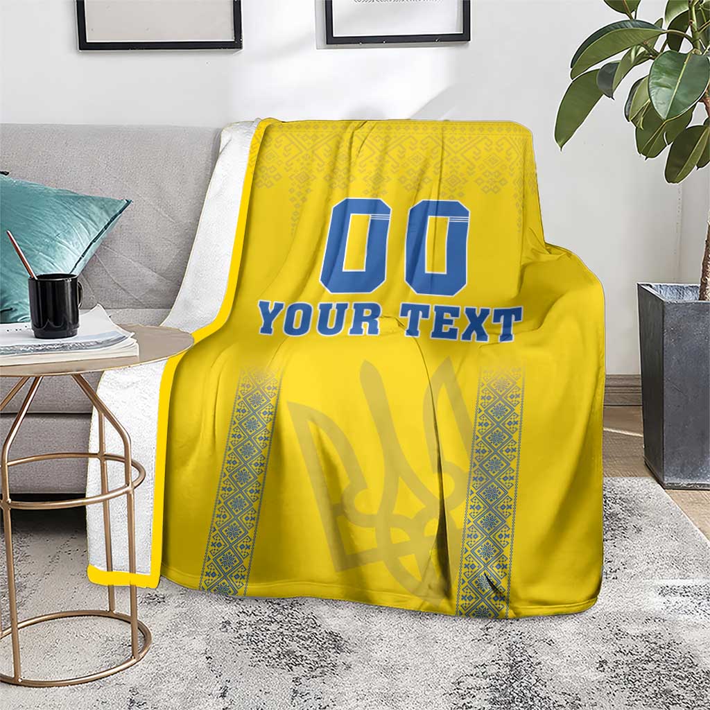 Yellow football-style blanket with blue “00” and “YOUR TEXT” print, patterned border panels