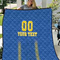 Blue quilt with diamond stitching, yellow "00" and "YOUR TEXT" design with side motifs