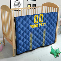 Blue quilt blanket on a wooden baby bed, diamond pattern with yellow "00" and "YOUR TEXT"