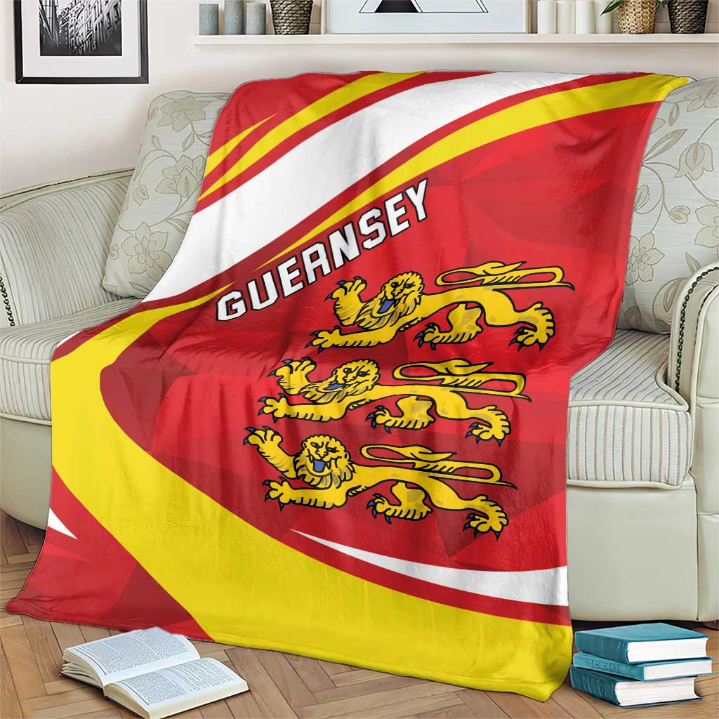 Red and yellow crest blanket with Guernsey wordmark, folded on a couch