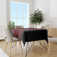 Black and red patterned tablecloth draped over a dining table