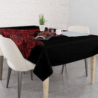 Black tablecloth with red abstract pattern along the tabletop edge