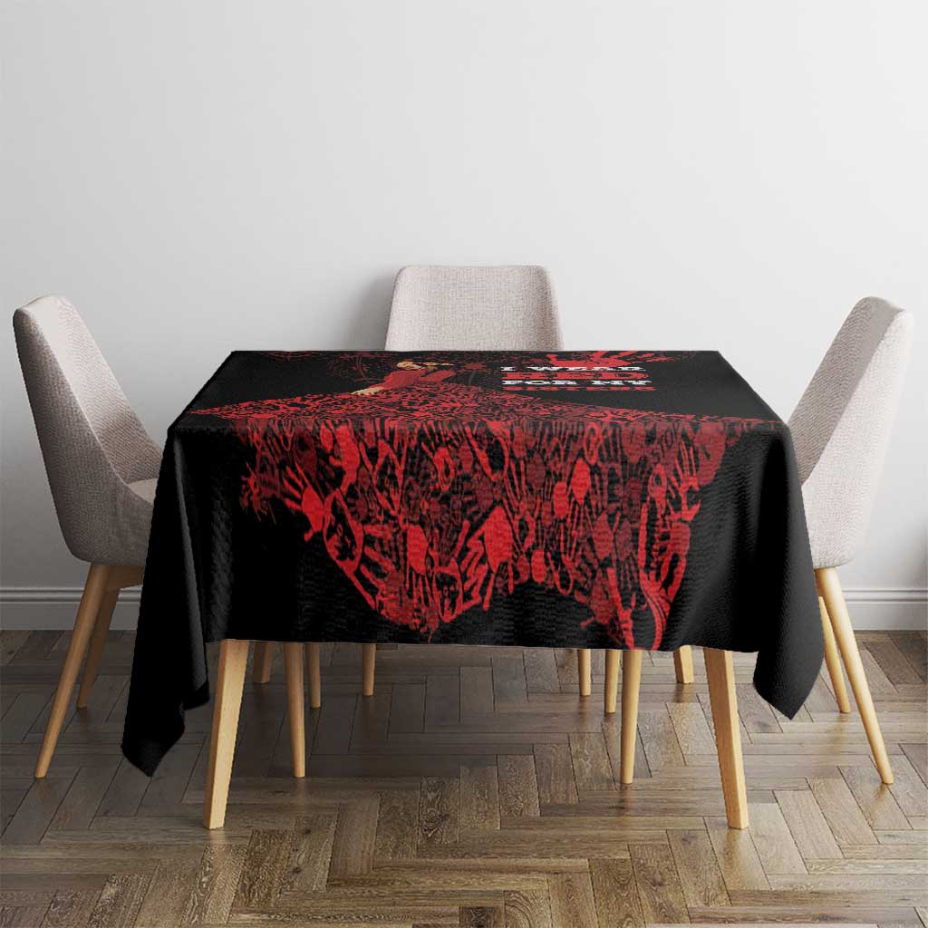 Black and red patterned tablecloth on a square table with four chairs