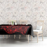 Black tablecloth with red wildlife-style pattern on a long dining table