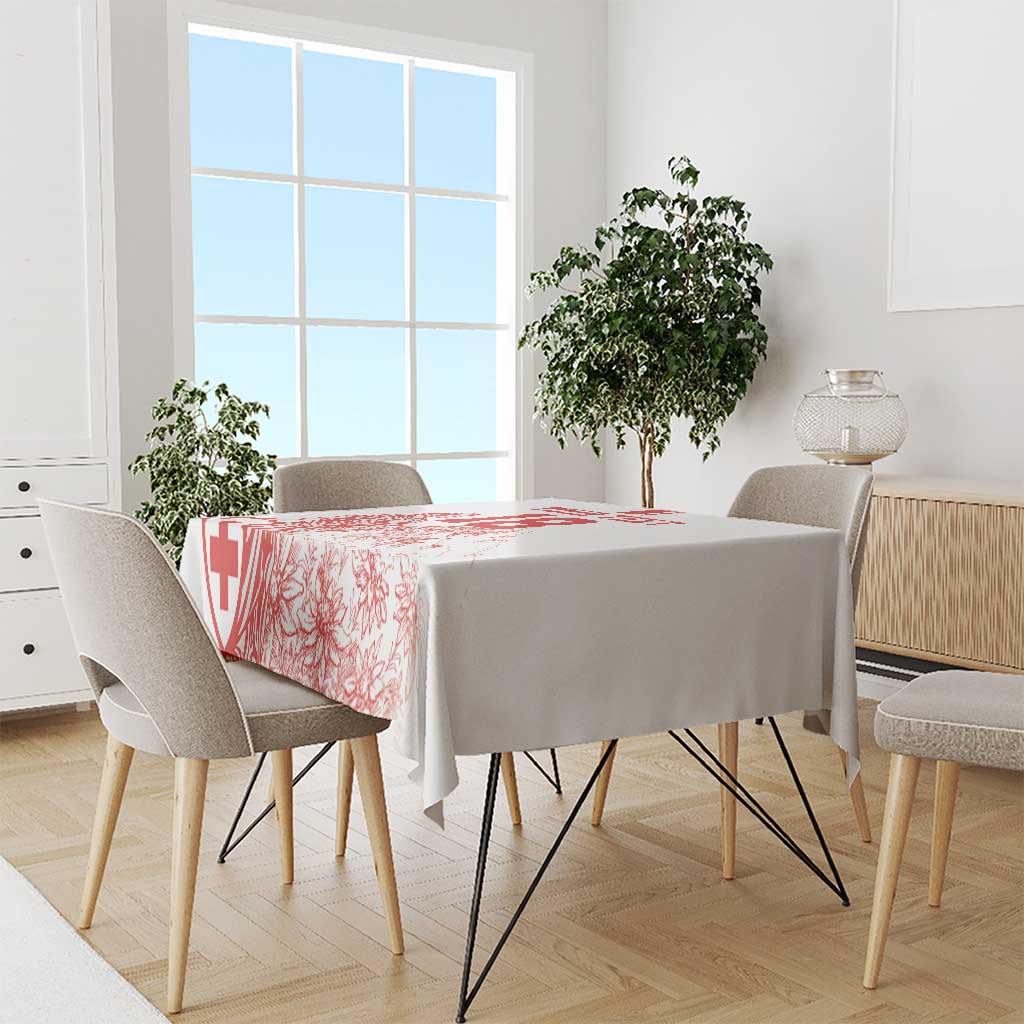 White tablecloth with red football-style graphic on a dining table