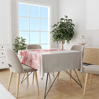 White tablecloth with red football-style graphic on a dining table