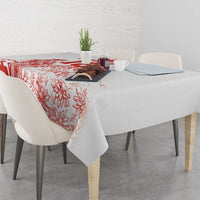 White tablecloth with red floral football pattern draped on a dining table