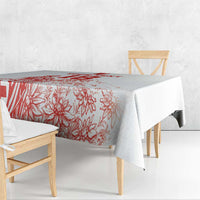 White tablecloth with red floral football print, draped over a bench