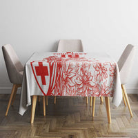 White tablecloth with red Swiss-style cross and floral football print