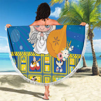 Round blue beach blanket with fringe edge and angel harp design, held open