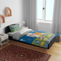Blue Christmas bedding set on bed with angel print, yellow squares, and matching pillow covers