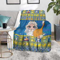 Blue Christmas blanket with angel print and yellow checker pattern, on living room couch