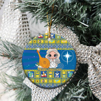 Blue ceramic Christmas ornament with angel artwork, round shape, hanging on a pine tree