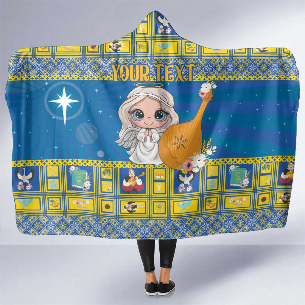 Blue hooded blanket with star-and-angel print and personalized text across the front