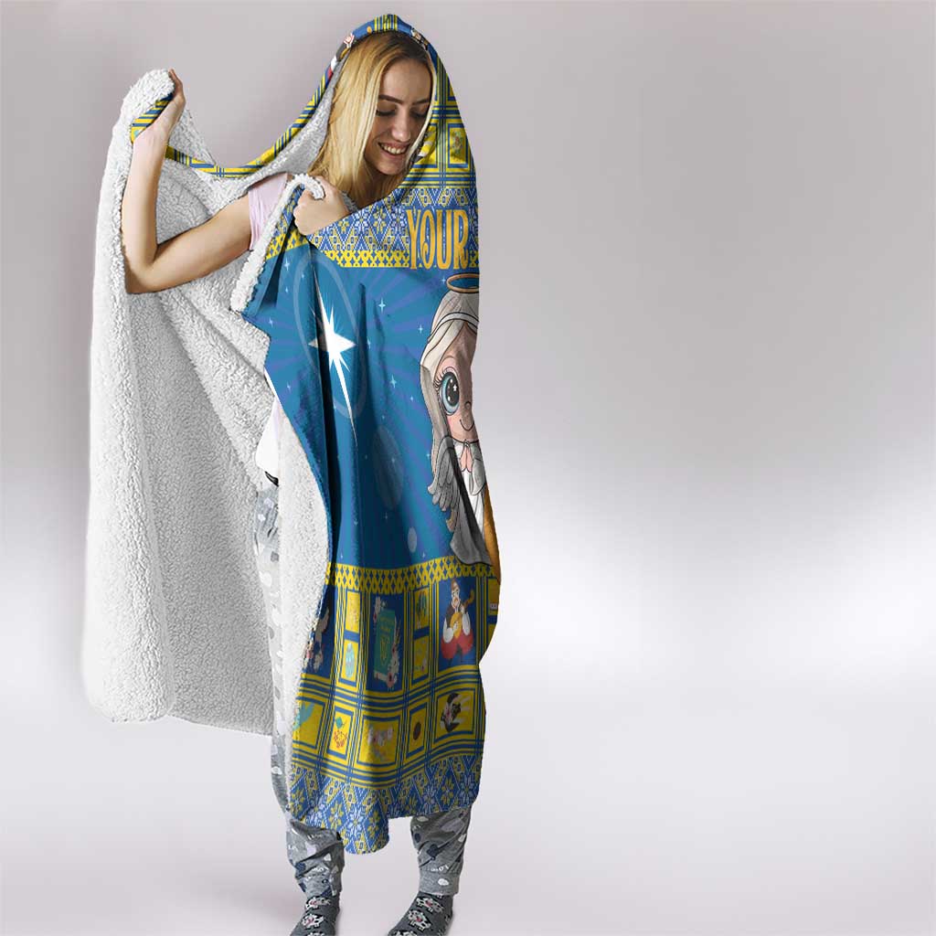 Blue hooded blanket with star-and-angel print, hood up and blanket draped over arms