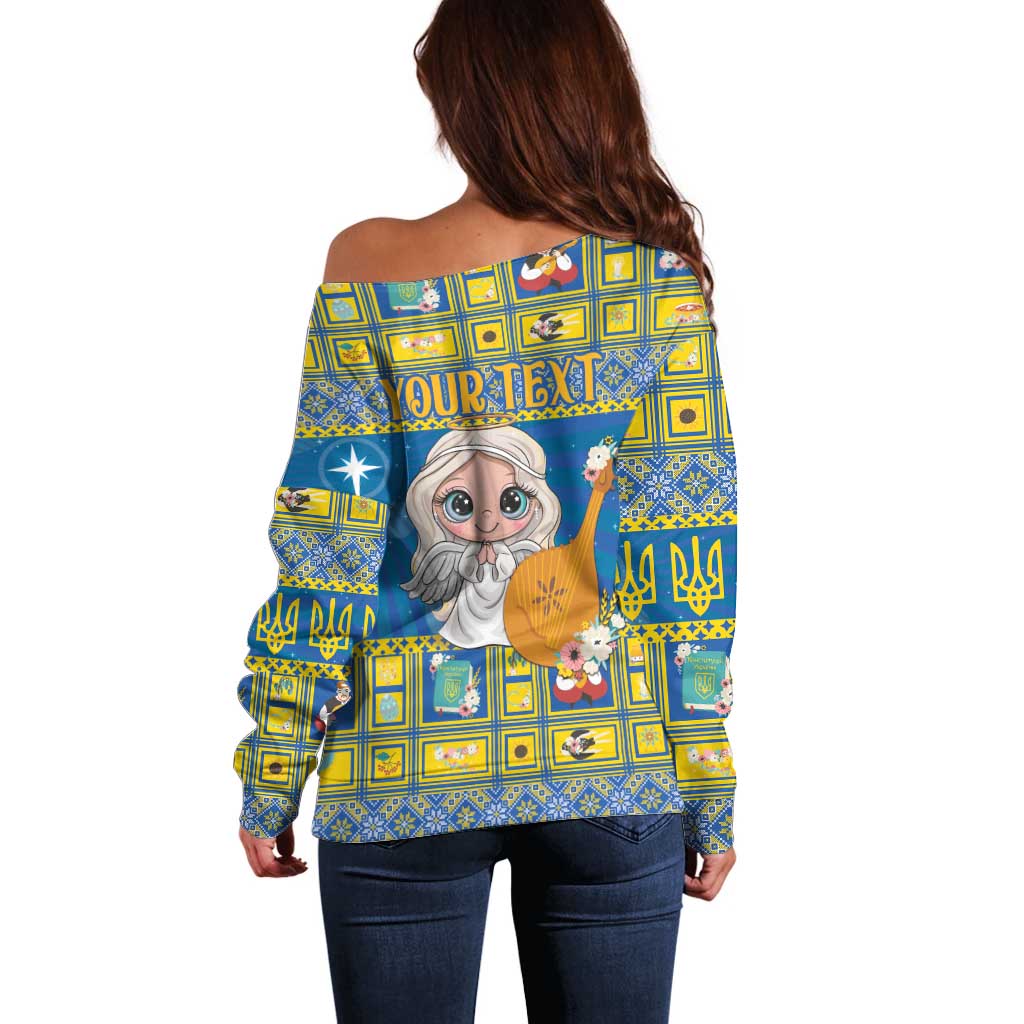 Women’s blue off-shoulder Christmas sweater, back view with angel graphic and text